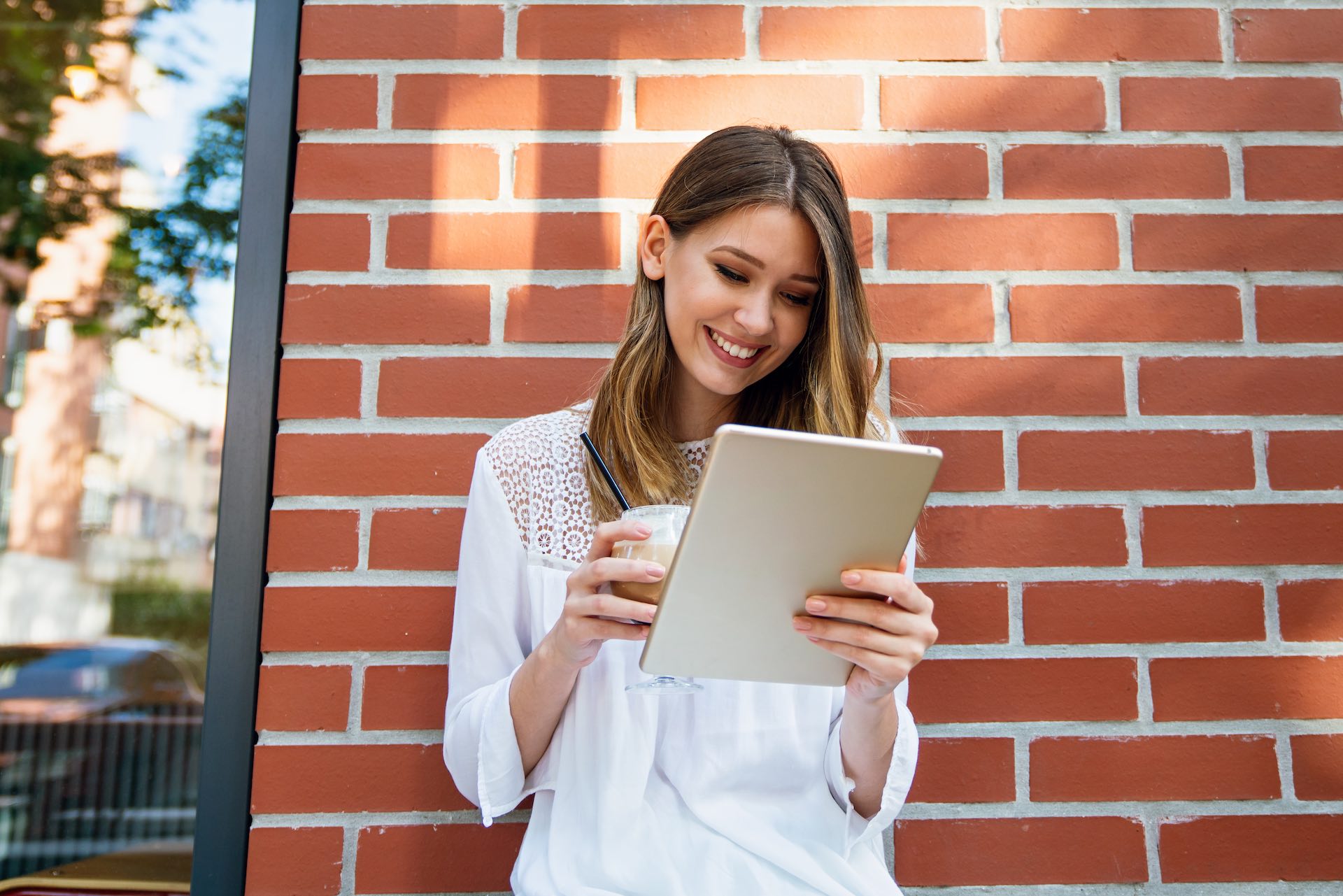 Digital device people work social media student concept. Happy young woman using digital tablet outdoors.