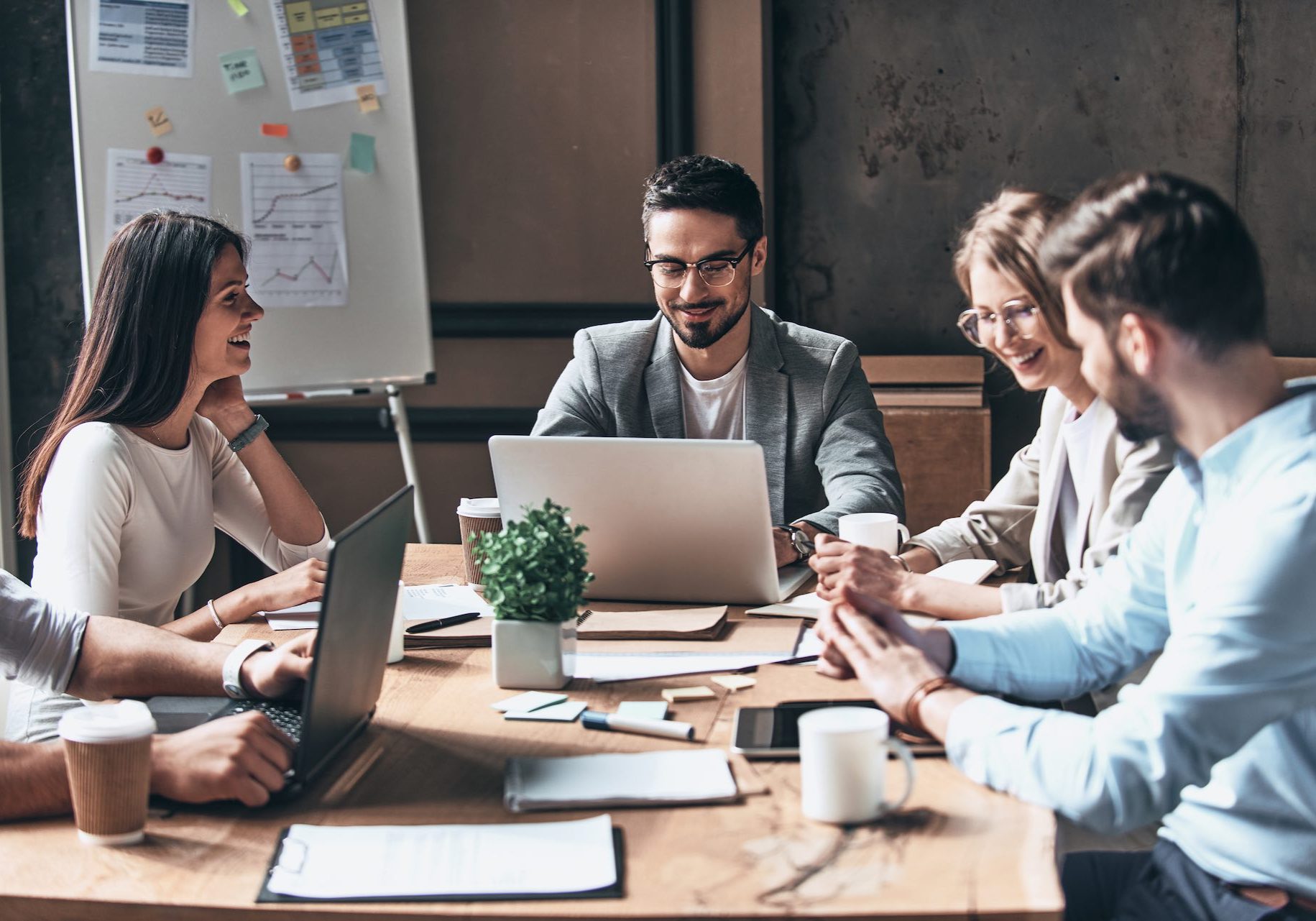 Business team. Group of young modern people in smart casual wear discussing business while sitting in the creative office